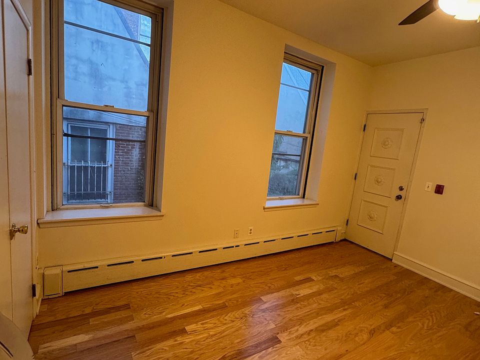 Bedroom has two windows, door that leads to outdoor porch. Another large closet on left of photo