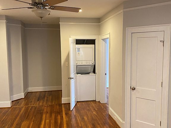 Living area with office nook, laundry, pantry and door to the second bedroom.