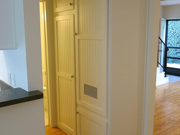 Hallway to downstairs bathroom. Storage in hallway.