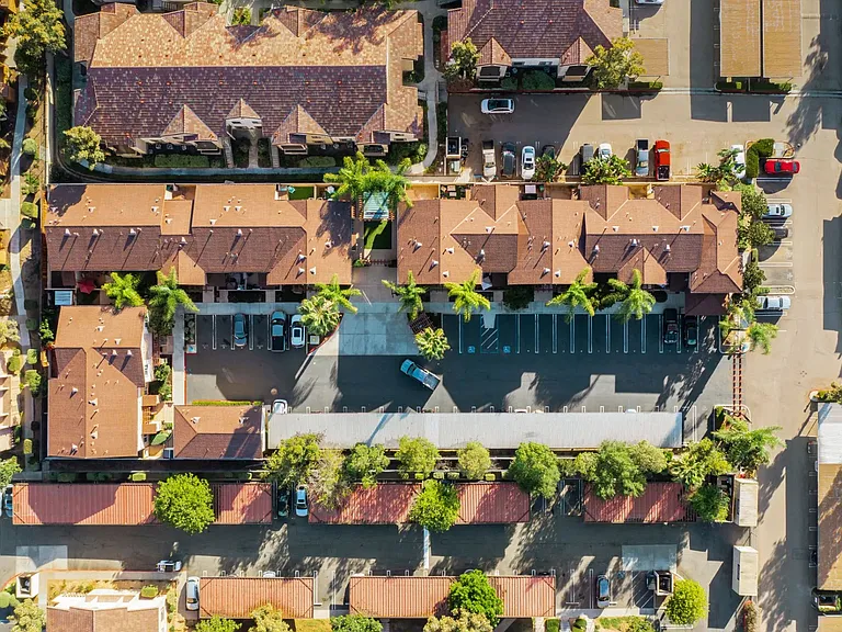 Aerial view of The Nines Townhomes showing parking, and covered parking in Escondido, California.