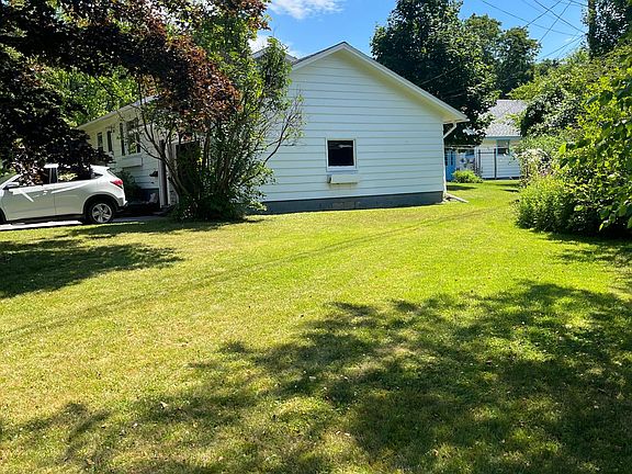 Large side yard with sunny area previously used for vegetable garden you can reclaim.