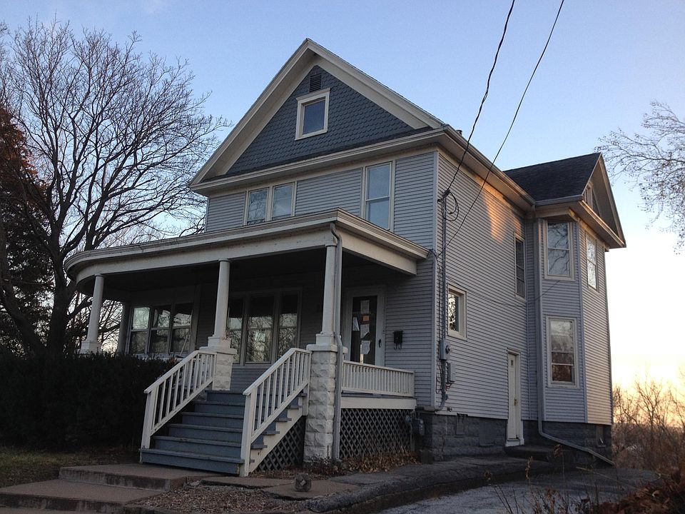 Front view with wrap around porch and 3 season room