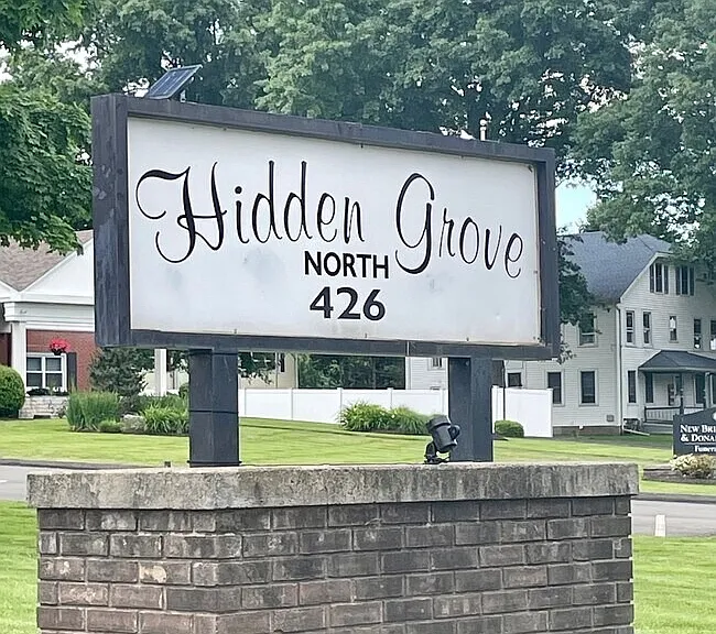 Entrance sign for Hidden Grove North 426; enter through Hidden Grove North and continue behind the front brick apartment building to access the condo units.