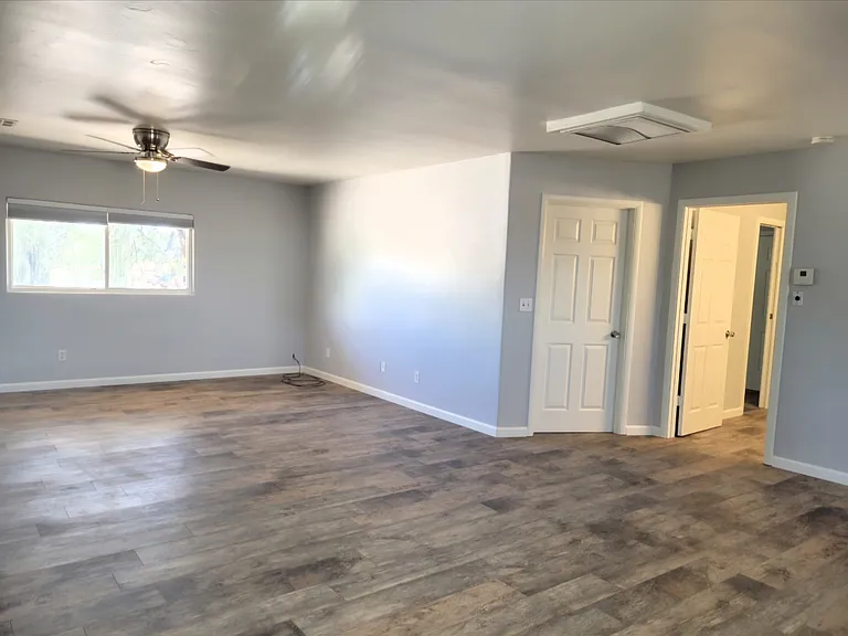From Kitchen, this shows the Family Room and the door into the bathroom (open) and the door into master bedroom (the door that is closed)