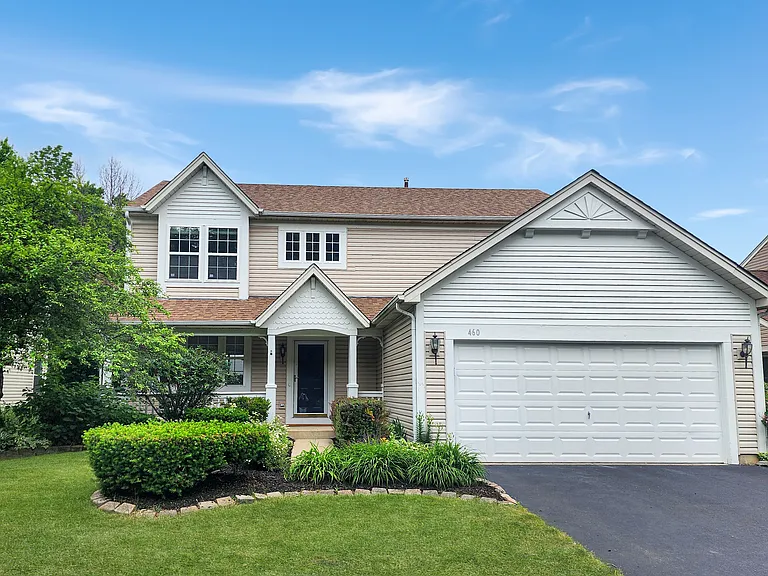 Exterior front with porch, beautiful landscaping and great curb appeal!