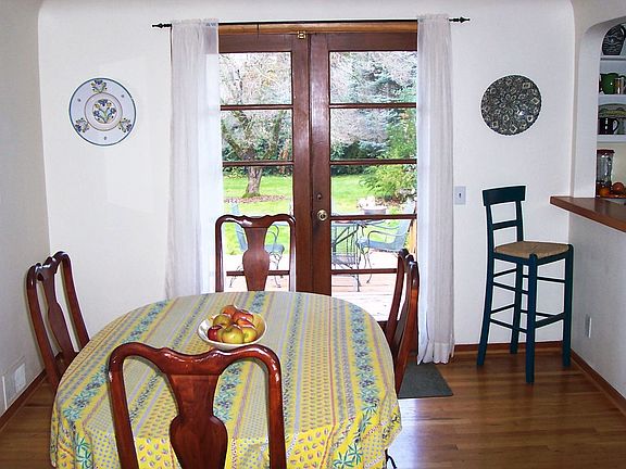 Dining room, french doors open onto deck overlooking backyard