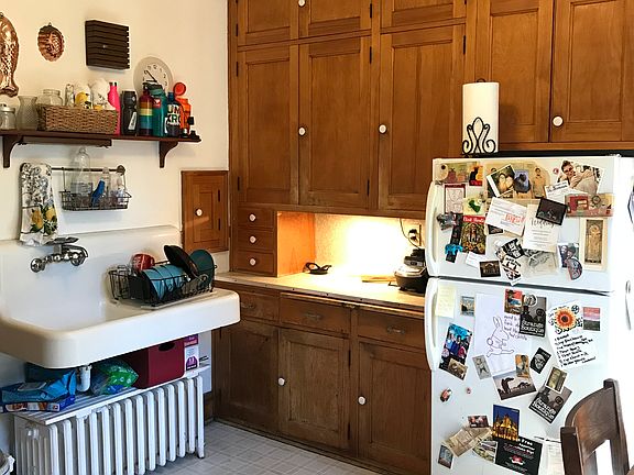 Ample cabinet space, beautiful builtins, original sink