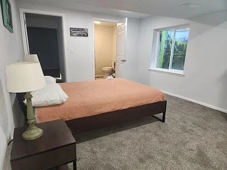 Lower bedroom with adjoining half bath and large closet. Bedroom is off the family room area.