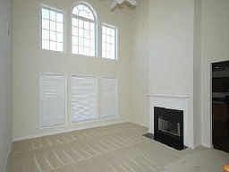 Two story great room with wall of windows and double sided fireplace. 