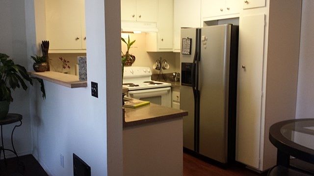 Kitchen has espresso wood floors