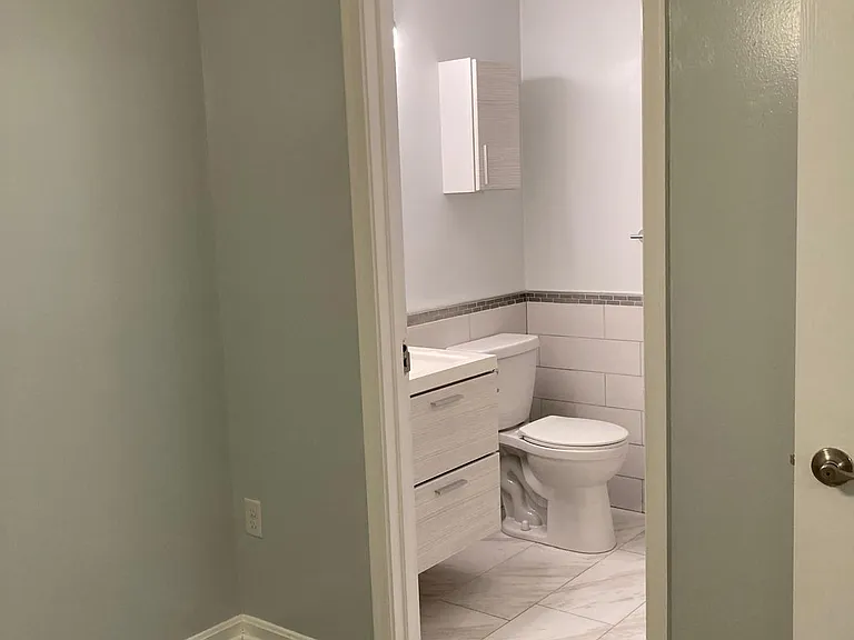 basement bedroom view into bathroom