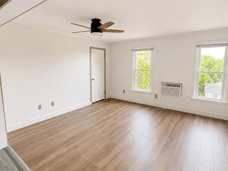 2nd floor living room with screened windows overlooks Joliet City from a comfortable distance the top of a hill. Great for natural light in the day, or a scenic view at night.