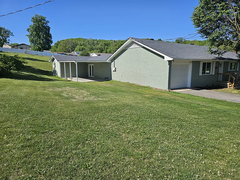 Large side yard with covered patio