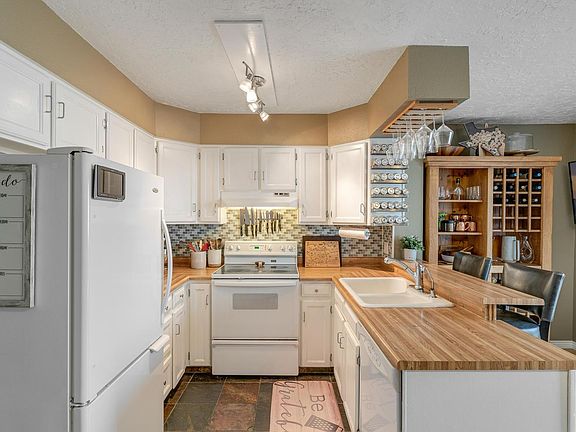 Track Lighting in Kitchen with spice rack and wine glass hanger