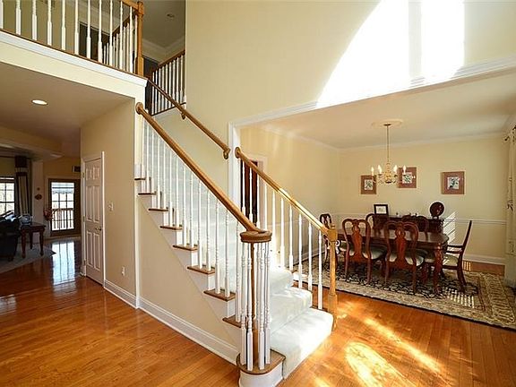 The beautiful open foyer leads to the dining room, living room, butler's pantry, family room and kitchen