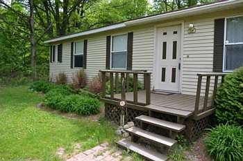 From the driveway you approach the home and the front porch.