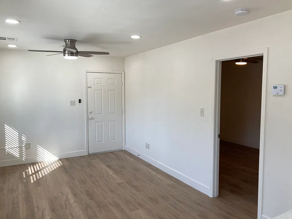 View from kitchen towards front door and bedroom door