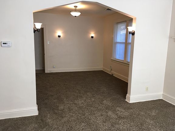 Looking into Dining Room 13 x 12 with wall sconce lighting
