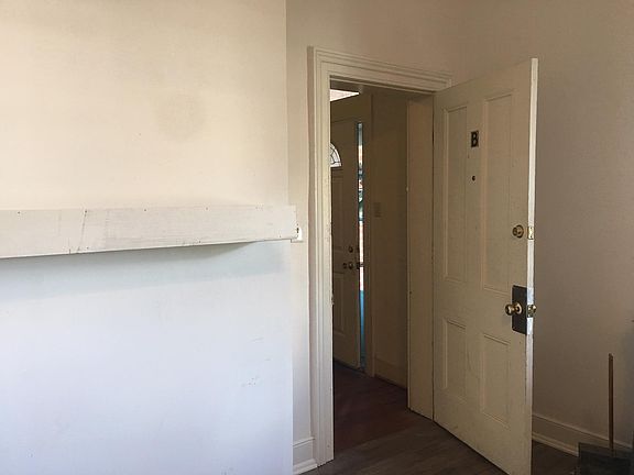Apartment door with view to foyer and front entry. Shelf now grey to match cabinets.