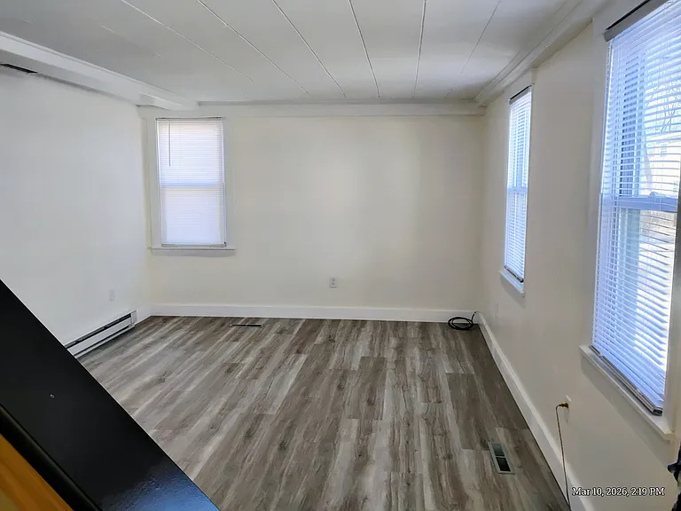 Deluxe 11x17 Living Room. Ceiling, walls and trim all just painted. Brand new high end, low maintenance flooring compliments the beige walls. 
3 Windows, so much control, what a comfortable living room!