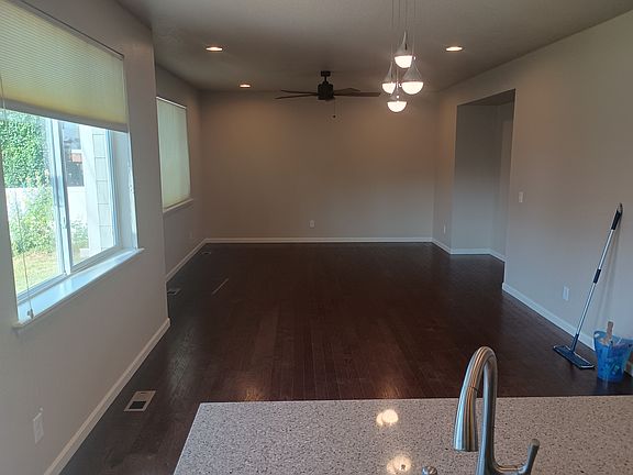 View from kitchen into family room. Ceiling fan in family room.