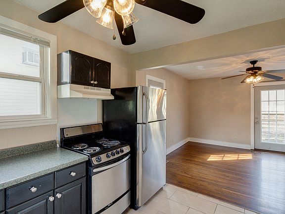 Open kitchen into the dining room with double doors to the deck