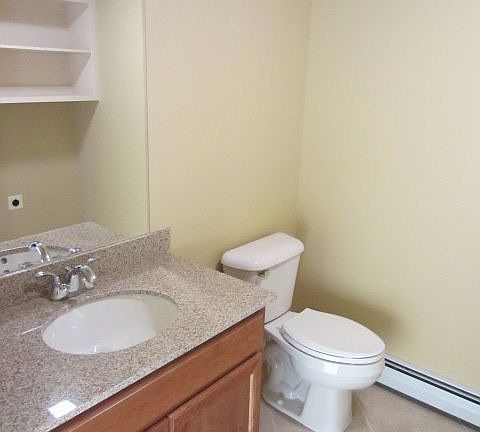 1st floor half-bath with granite counter-top and ceramic tiled floor