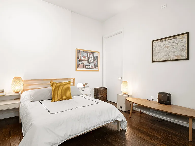 Comfortable Primary Bedroom with Hardwood Floors