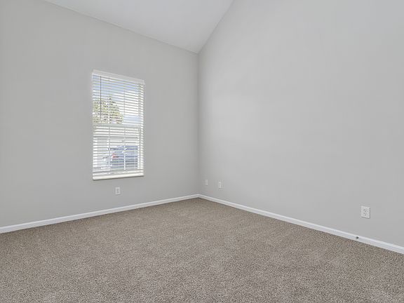 Orleans Metairie Deluxe Renovated downstairs bedroom with vaulted ceiling and plush carpet