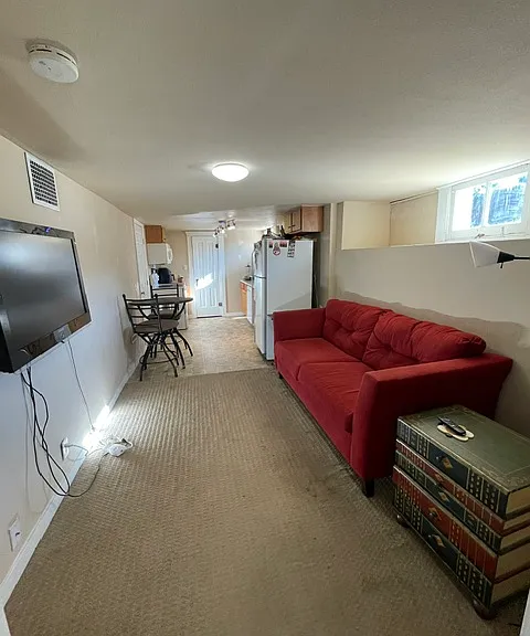 living room to kitchen area w/ wall mounted TV
