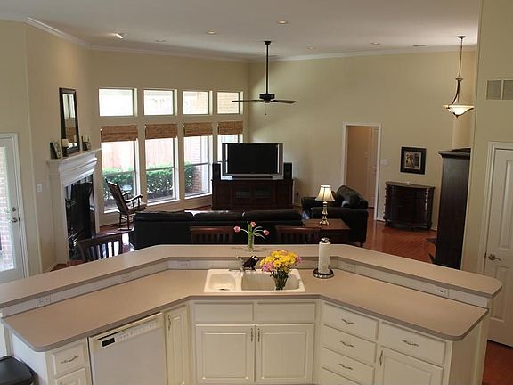 Kitchen Island with Wrap-Around Bar Opens to Living Area