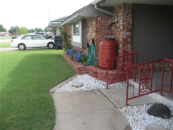 Here is another look. Lovely approach and the rain barrel will save rain water for watering the grass, or if you prefer, the seller will remove the barrel and replace the down spout.