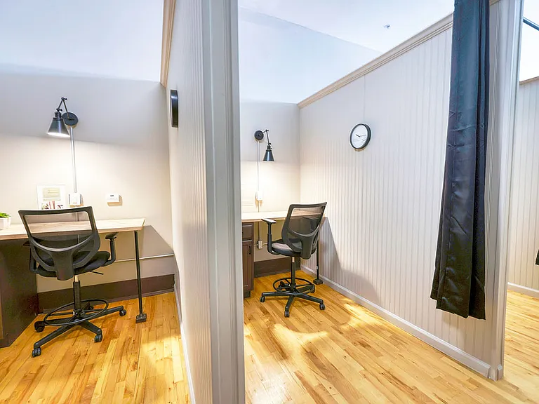 Multiple desks with divider-curtains coworking space desks chairs