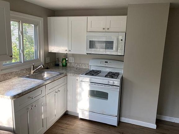Newer Shaker white cabinets in kitchen with two year old appliances