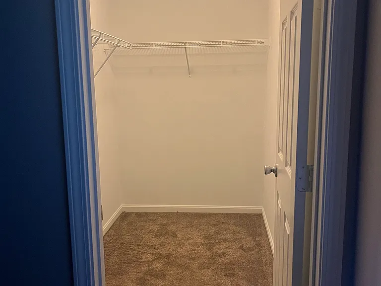one of the walk in closets in primary bedroom