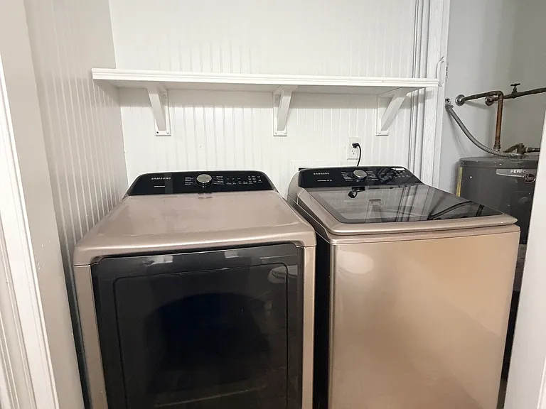 Full sized washer and dryer located on first floor, next to two bedrooms, and nested away within first floor bathroom
