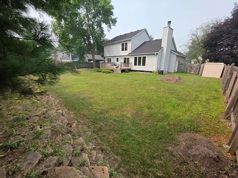 Fenced back yard with deck.