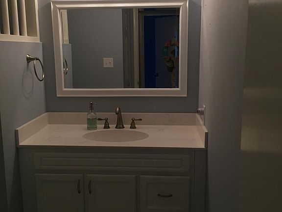 Each bathroom is updated with marble tile, and mirror and co