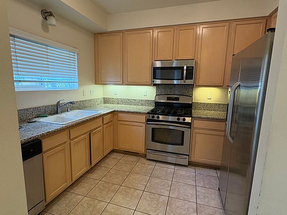 Modern kitchen with stainless-steel appliances, granite top and counter space