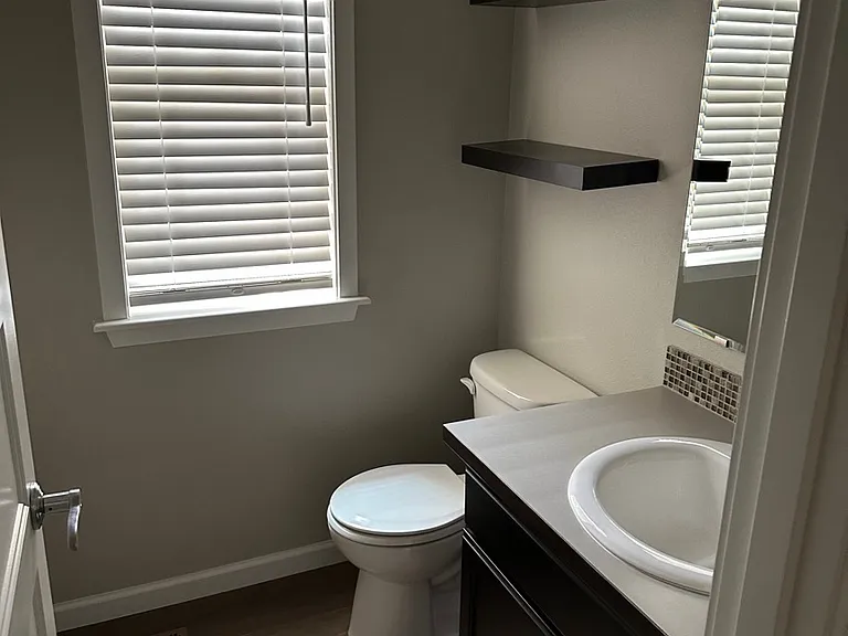 Half bathroom conveniently tucked off the entrance of the home.