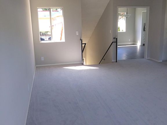 Living room facing stairs and dining room.