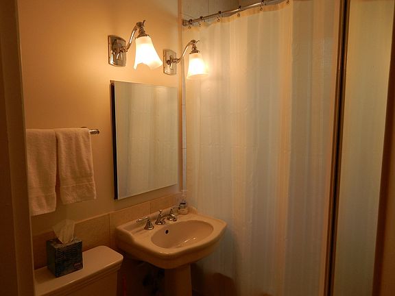 Cute bathroom with tub and shower located in betwe