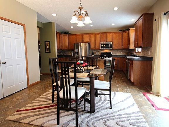 View of kitchen and informal dining area from the family room. Pantry on left.