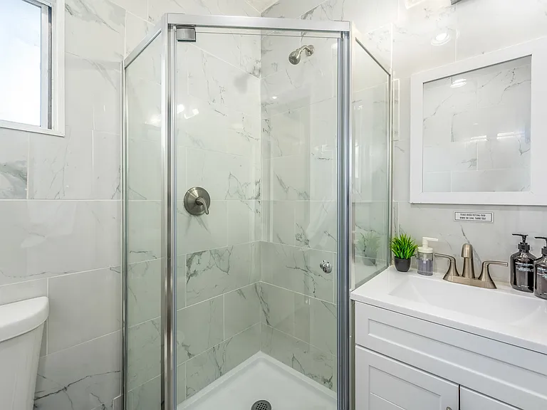 Enjoy the ease of a spacious vanity, perfect for your morning or evening routines.
Clean and inviting 2nd bathroom has everything you need for a relaxing experience.