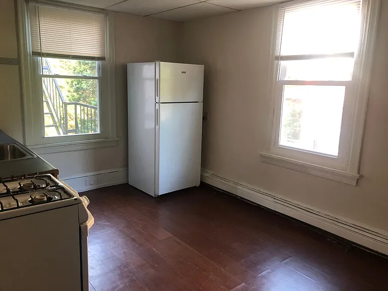 Large updated kitchen with dishwasher and two large windows.