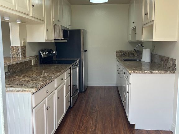 Galley kitchen with new floor, countertop and appliances