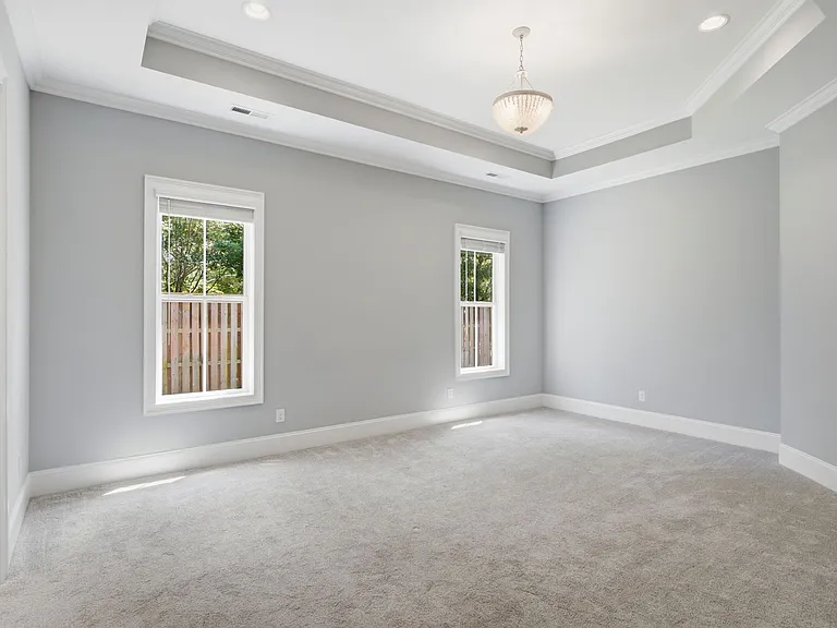 Primary Bedroom with tons of light and tray ceiling