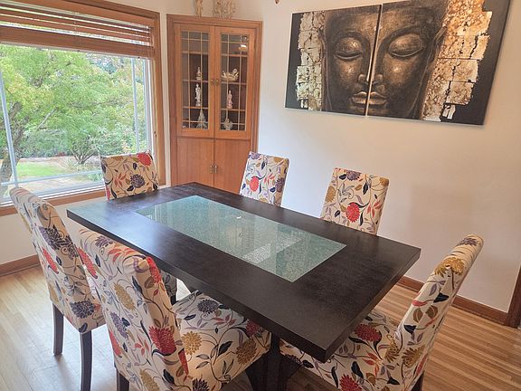 A cozy, modern dining area for six people with garden view.