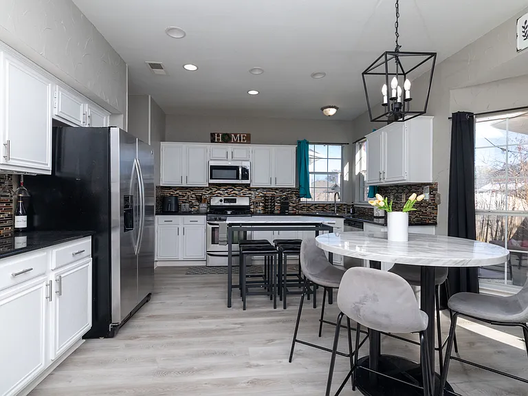 Bright, modern kitchen with a sleek island and cozy dining area.
