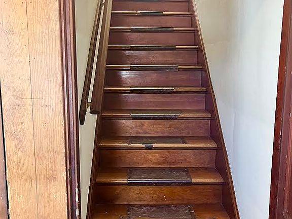 Enter the front door of the building and stairs lead up to Unit #2S